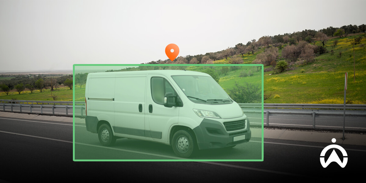 Courier vehicle parked near countryside road, representing hijacking of courier vehicle threats.