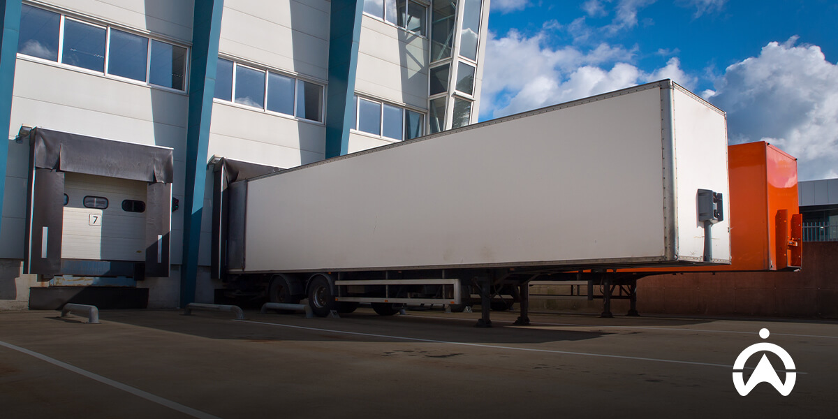 White freight trailer at loading dock demonstrating non-powered asset tracking for stationary cargo.