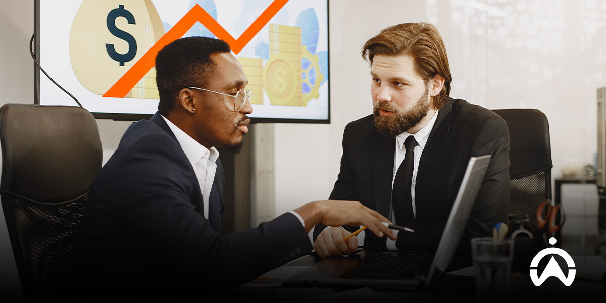 Two professionals reviewing fleet performance data to illustrate fleet benchmarking.