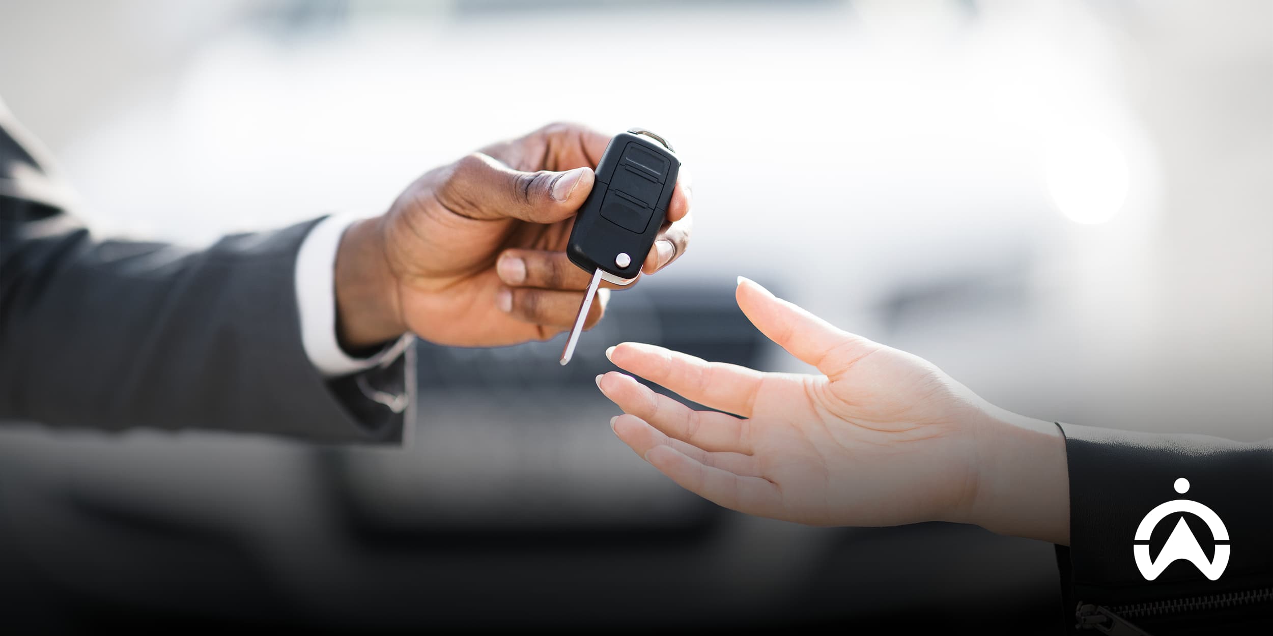 Person handing over car keys during a second-hand car purchase inspection.