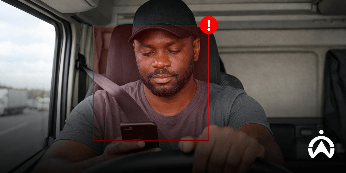 Driver holding phone while driving, highlighting shift from reactive safety to proactive fleet safety with Cartrack driver monitoring system.
