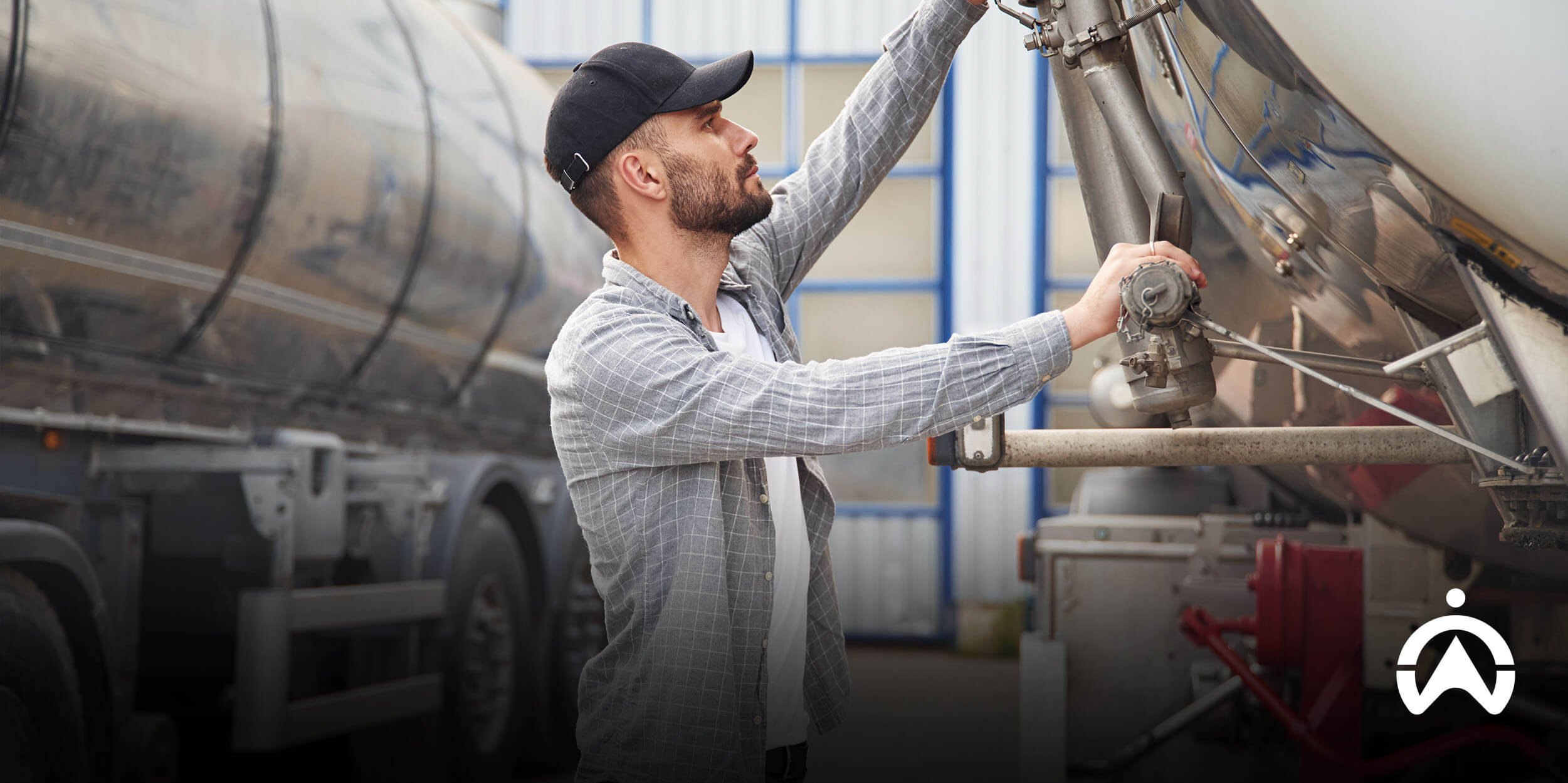 Technician inspecting tanker valves during fuel calibration to ensure accurate fuel monitoring.