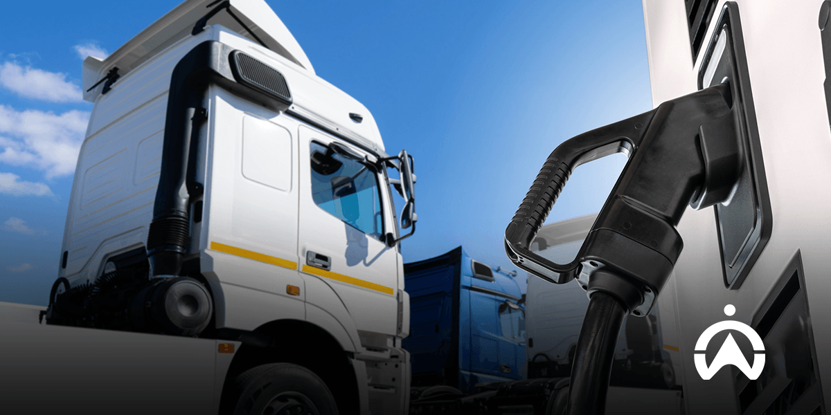 Commercial semi-truck refueling, illustrating the transition to fleet telematics systems that monitor EV battery health.