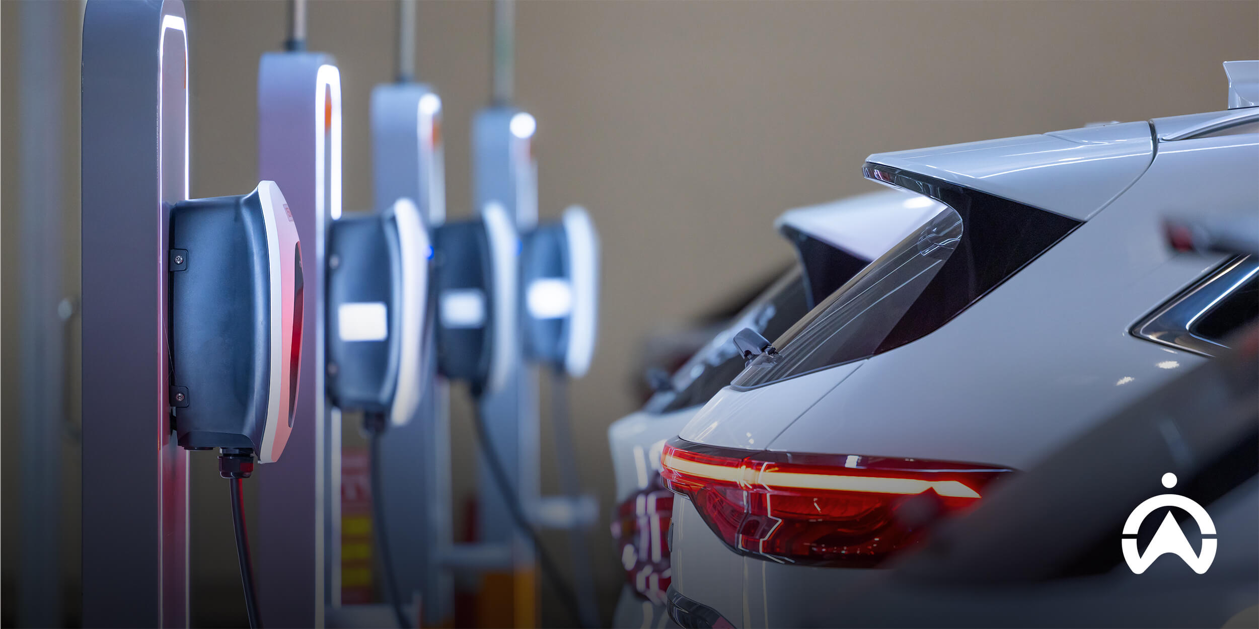 White electric cars parked at an indoor facility to showcase how much it costs to charge an electric car in South Africa.
