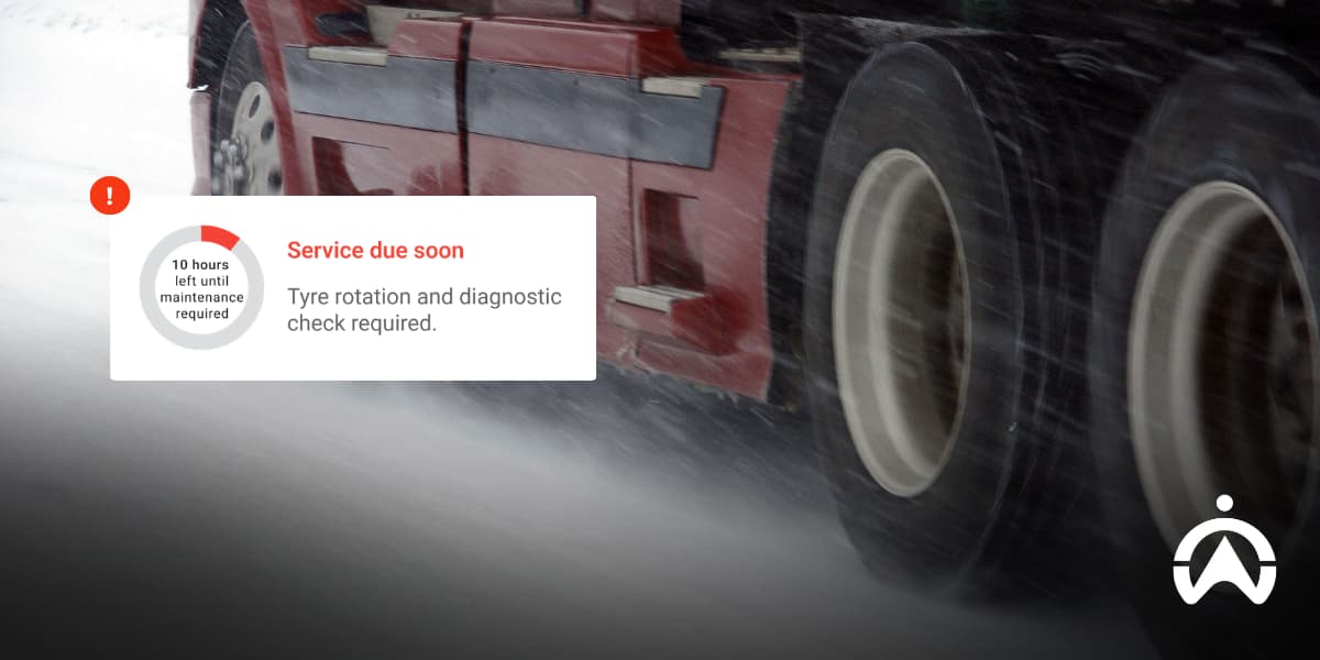 Close-up of truck tyres on a snowy road with maintenance alert, highlighting cold weather maintenance tips for your trucks and winter tyre checks