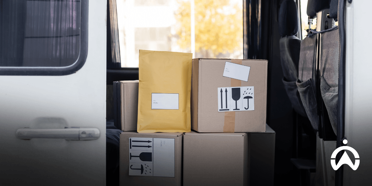 Packages stacked inside a delivery van with open side door, illustrating where to buy rugged fleet cameras for delivery vans and improve cargo security