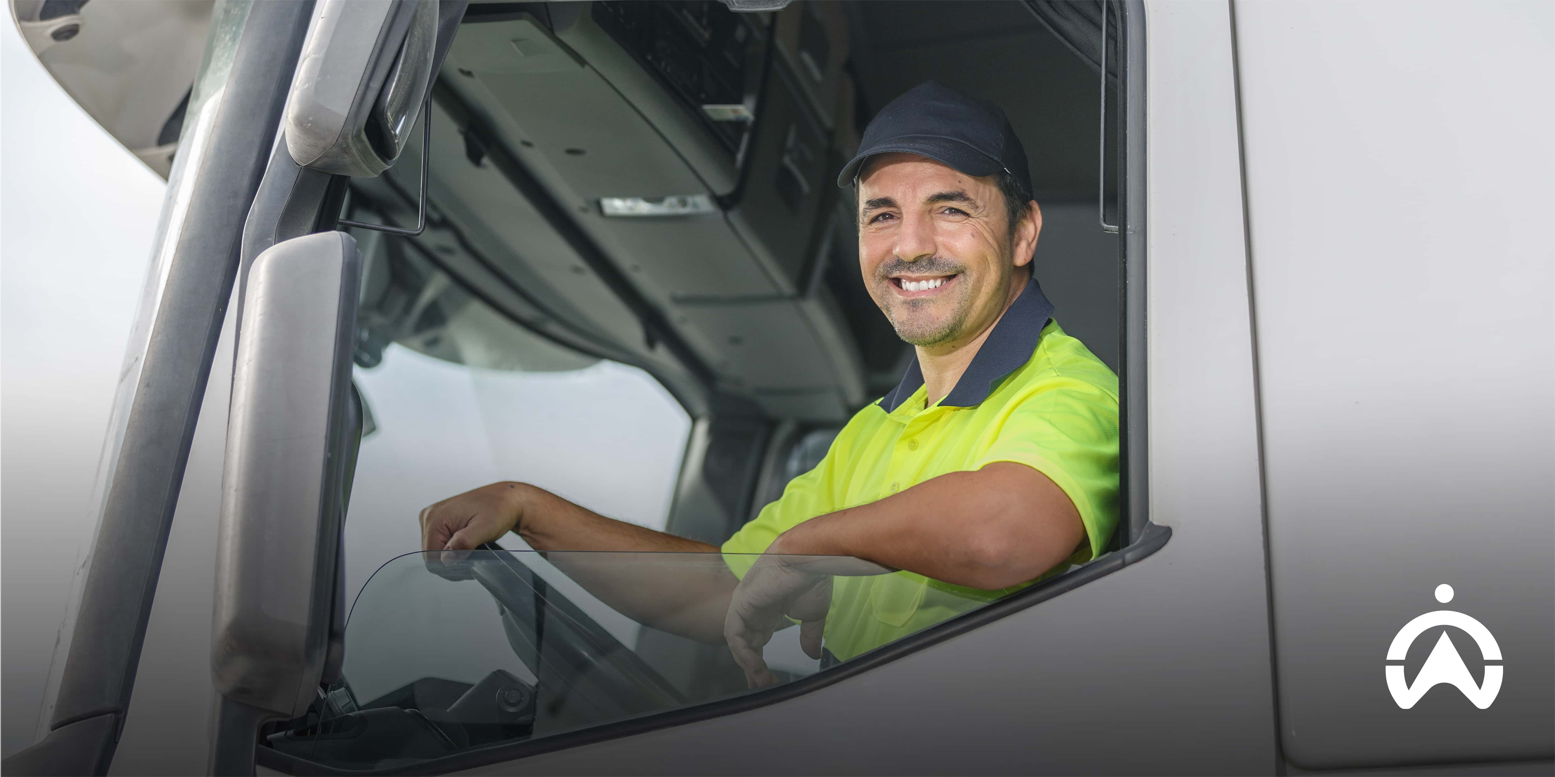 Truck driver sitting inside a truck cab, illustrating how to stop data fatigue in your trucking company through better fleet visibility and simplified reporting