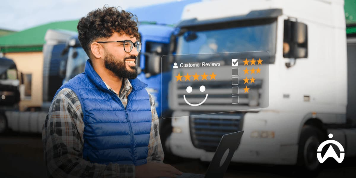 A smiling logistics manager with a laptop stands by trucks, with a five-star customer review overlay showcasing top-rated fleet camera reviews.