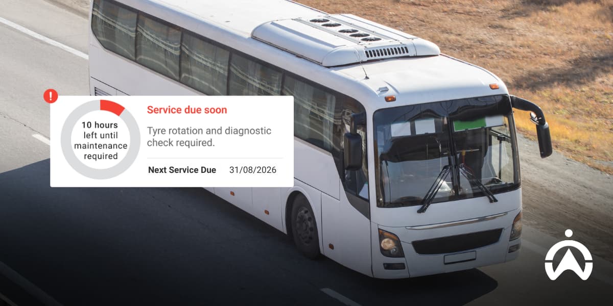 White passenger bus with maintenance alert, demonstrating global fleet management through proactive vehicle servicing and monitoring.