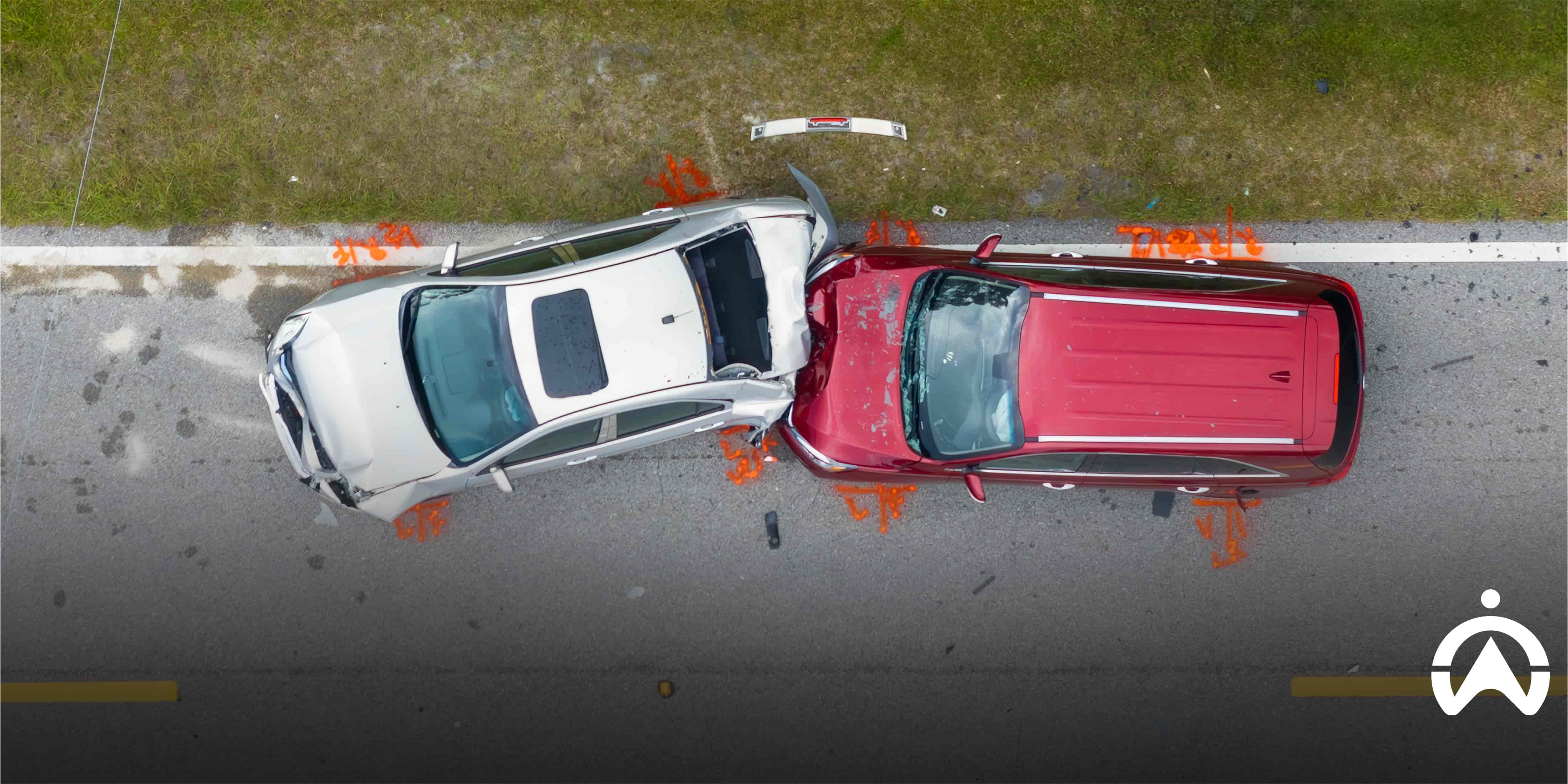 Aerial view of a staged vehicle collision, illustrating crash for cash fraud and insurance scam risks.
