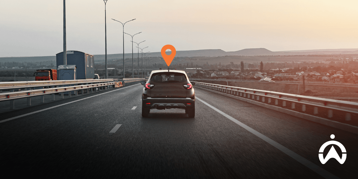 Car driving on a highway at sunset with GPS location pin, representing the best car tracking device in South Africa.
