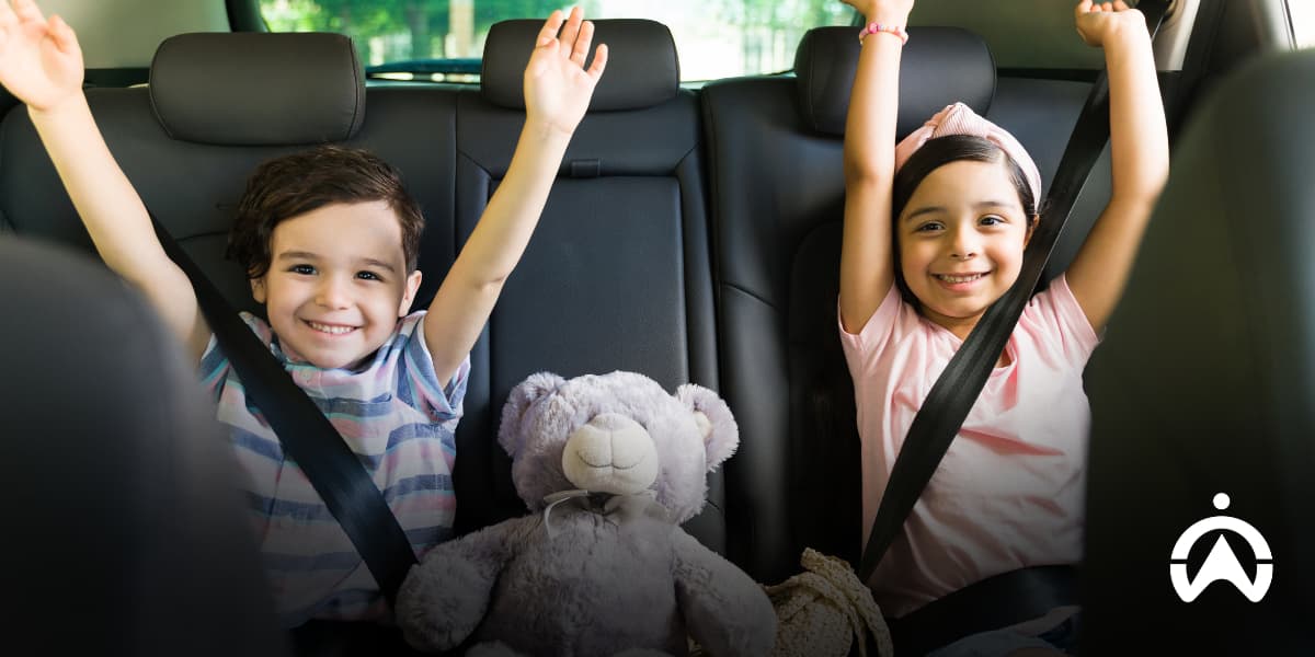 Children wearing seat belts in the back seat, showing how to keep your child safe in a hijacking.