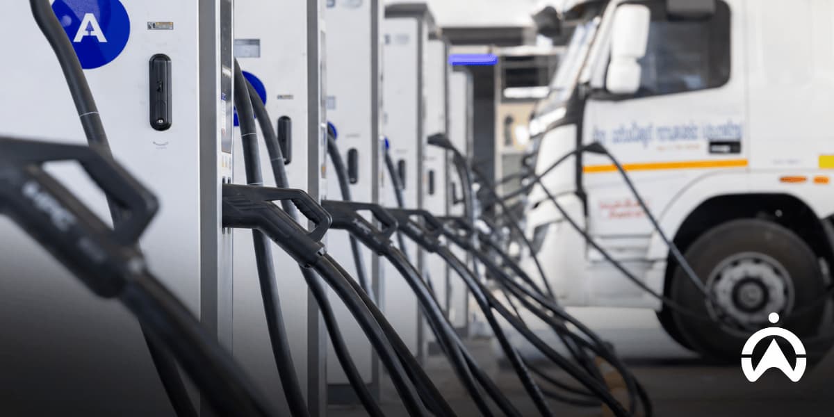 Fuel pumps and a white tanker truck illustrating fuel cost comparisons when calculating fleet electrification ROI.