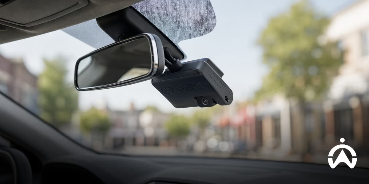 Dashcam mounted beside a car’s rearview mirror, highlighting camera placement for reliable performance throughout its lifespan.