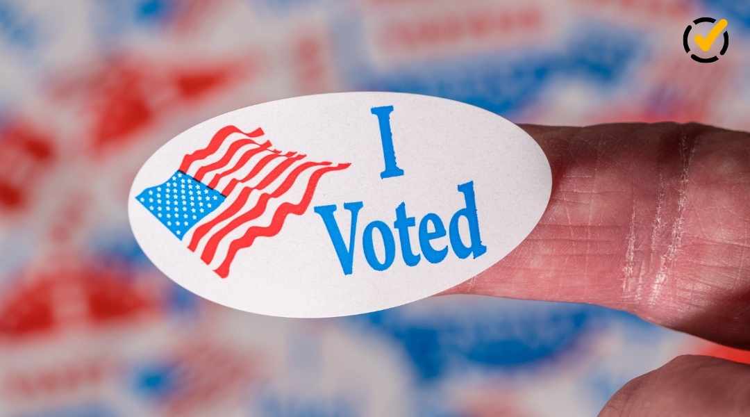 "Close-up of a finger holding an oval 'I Voted' sticker with an American flag design, against a blurred background of more 'I Voted' stickers. The Formative by Newsela logo is in the top right corner."