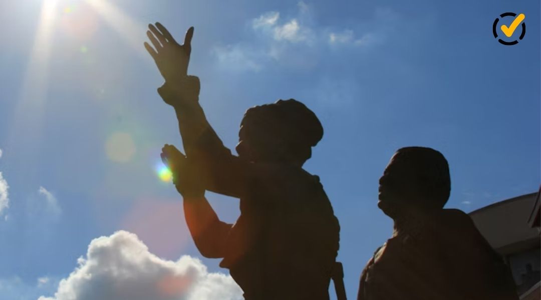"A silhouetted statue of two figures with arms raised towards a bright sun in a blue sky with clouds. The Formative by Newsela logo is in the top right corner."