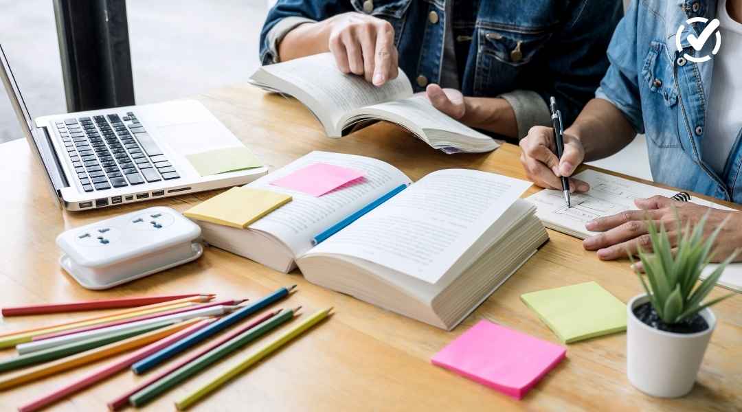 "Two students are seen from the chest up, studying at a wooden table with open books, a laptop, pencils, and sticky notes. The Formative by Newsela logo is in the top right corner."