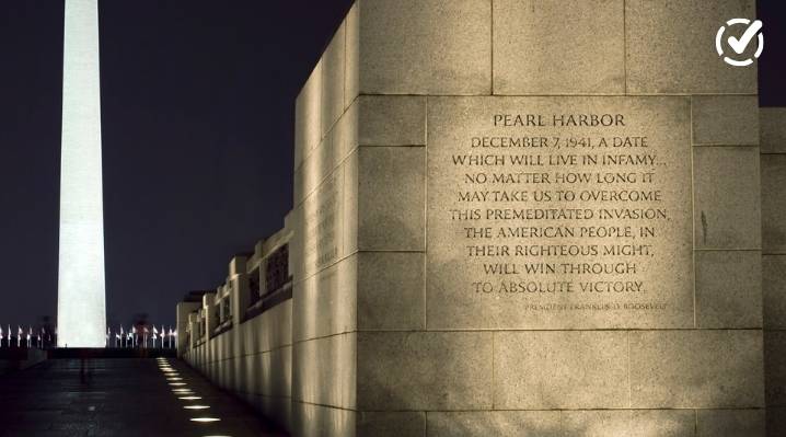 "A close-up of a stone monument engraved with Franklin D. Roosevelt's 'Pearl Harbor: A Date Which Will Live in Infamy' speech, with the Washington Monument blurred in the background against a dark sky. The Formative by Newsela logo is in the top right corn