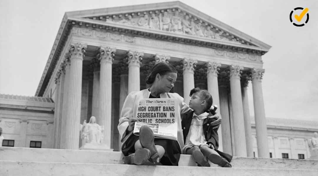 "A black and white photo of an adult woman holding a newspaper with the headline 'High Court Bans Segregation in Public Schools' while a child sits next to her, both looking at each other on the steps of the Supreme Court building. The Formative by Newsela