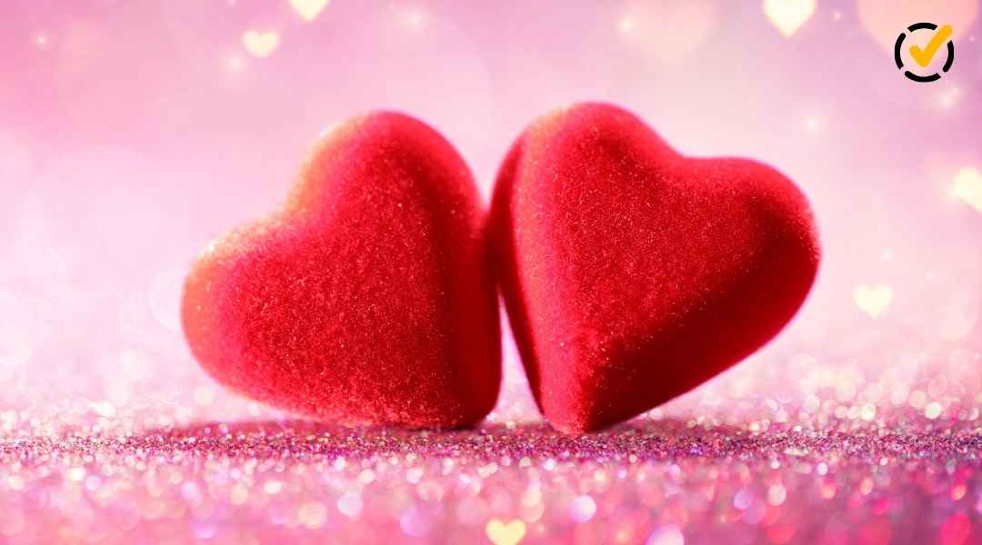 "Two plush red hearts sit side by side on a sparkling pink surface, with blurred heart-shaped bokeh lights in the background. The Formative by Newsela logo is in the top right corner."