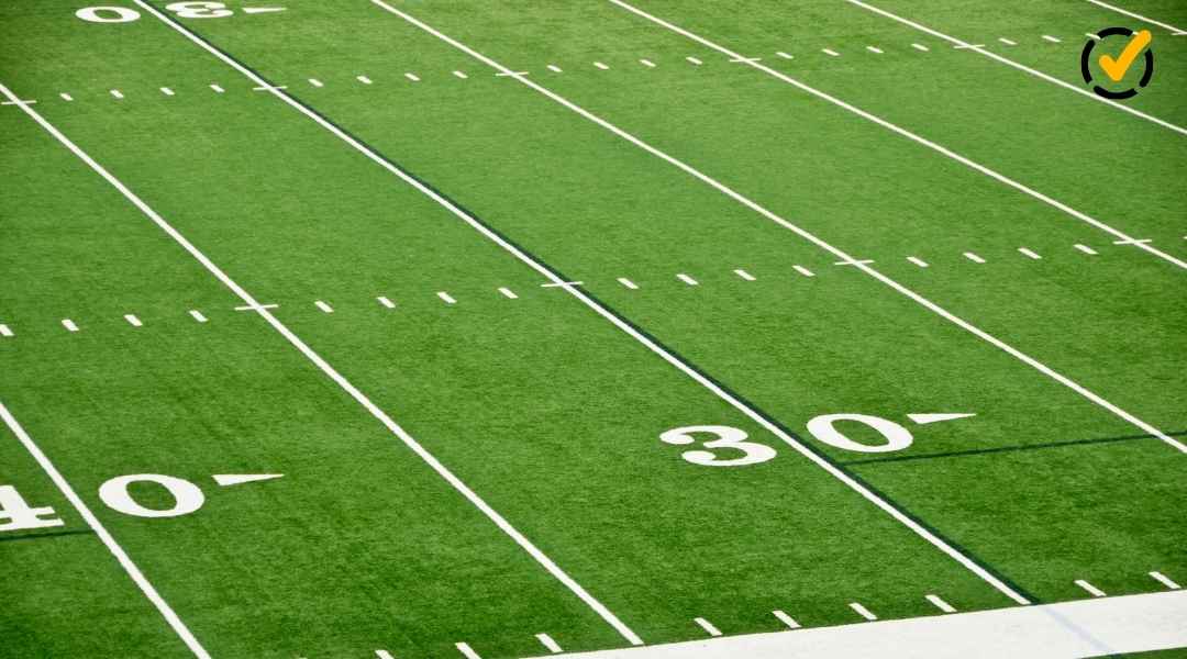 High-angle view of a green American football field with white yard lines and a Formative logo in the corner.