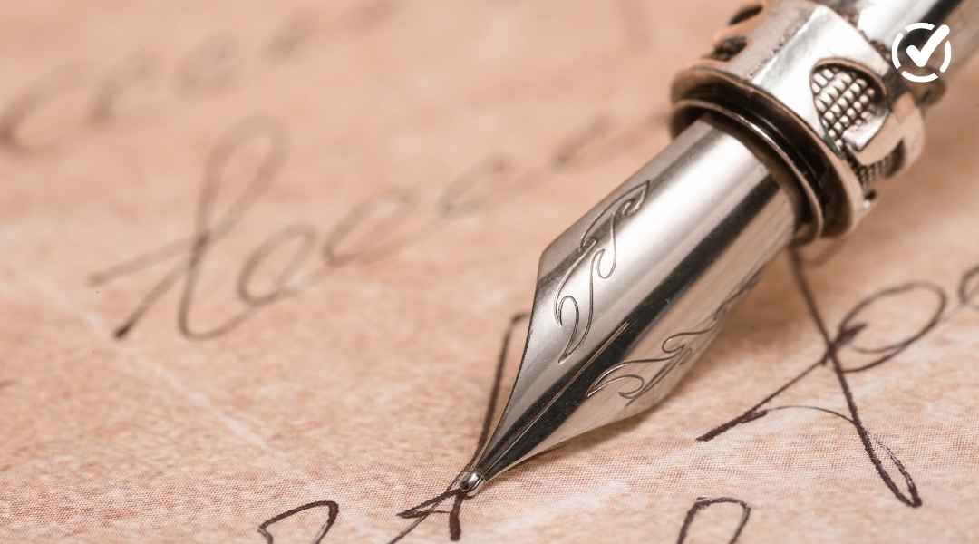 Close-up artistic shot of a silver fountain pen nib resting on vintage parchment paper with elegant cursive script, representing National Poetry Month.