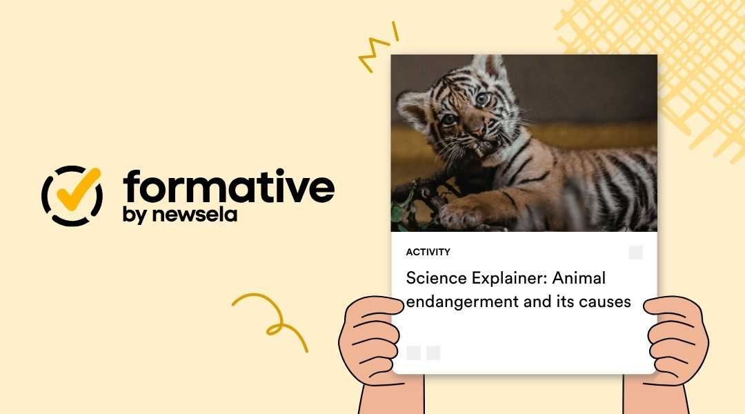 Science Explainer activity: Animal endangerment and its causes. The card features a close-up photograph of a young tiger cub resting among foliage.
