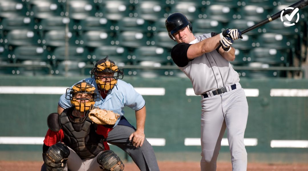 Baseball player swinging at bat during a game for World Series classroom activities