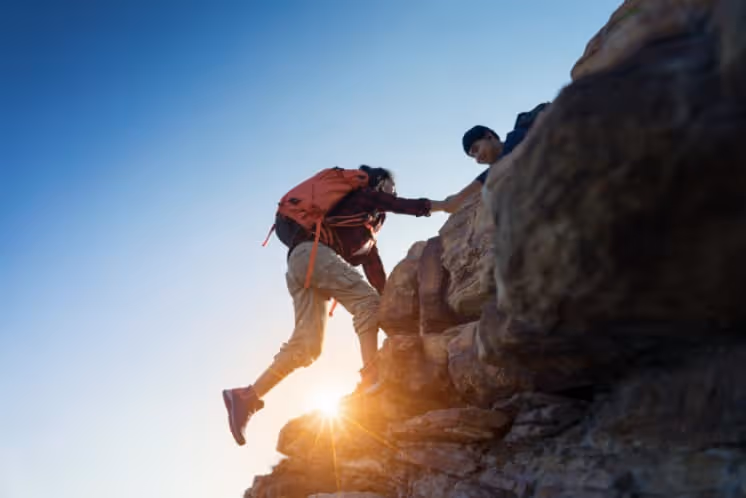 Person Climbing a hill on sunset