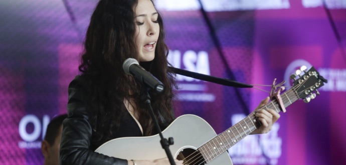 A female playing guitar
