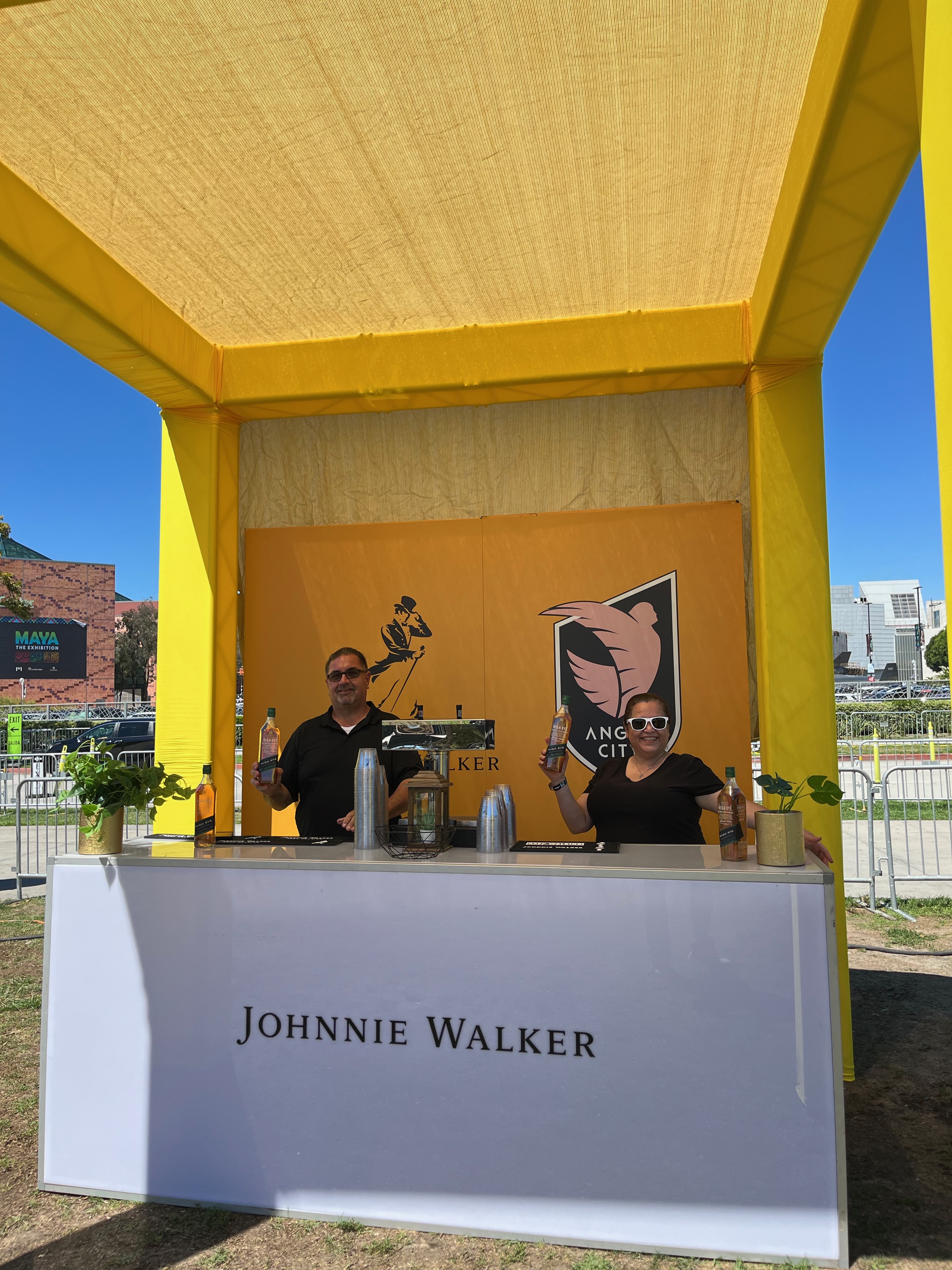 Johnnie Walker Angel City partnership booth bar white with yellow awning
