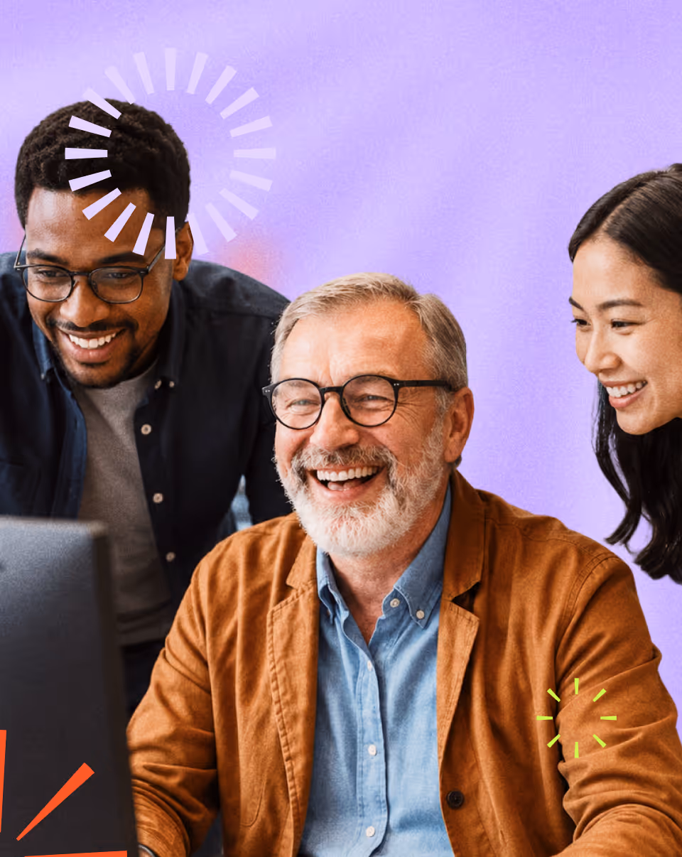 Three diverse coworkers smiling and looking at a computer screen with a purple background.