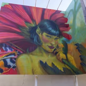 Mural of a woman in front of a large flower