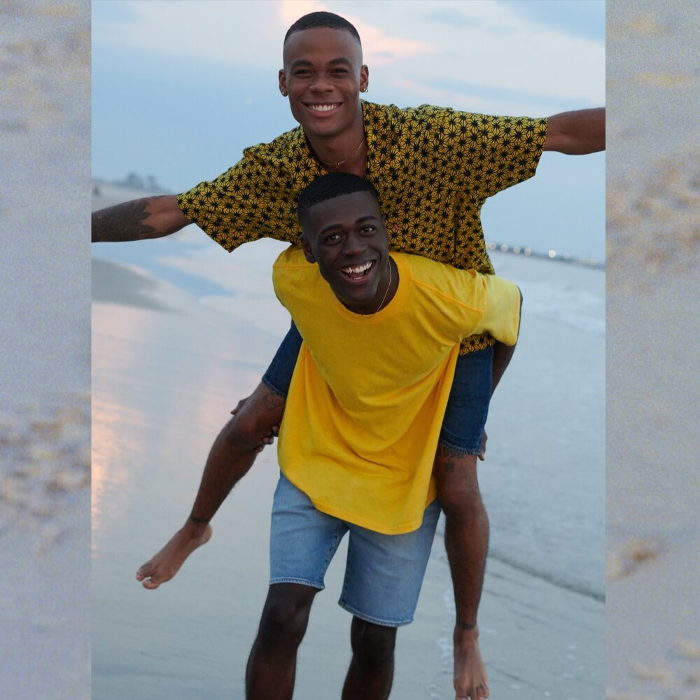 Two young men on a beach wearing Levi's clothing