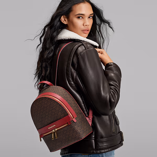 woman wearing michael kors backpack