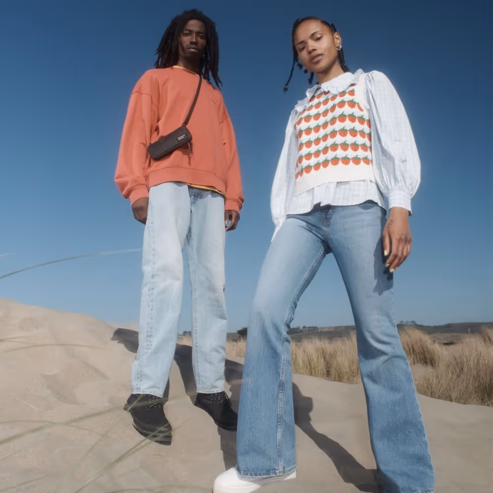 Two models wearing Levi's apparel on a sand dune