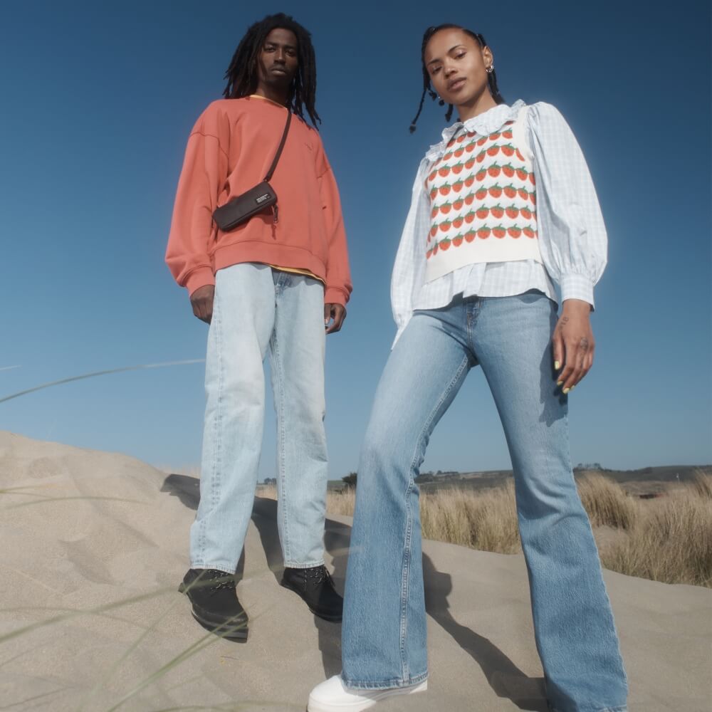 Two models wearing Levi's apparel on a sand dune
