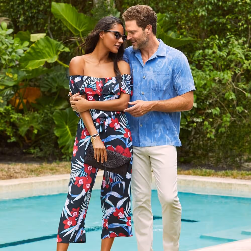Young couple wearing Tommy Bahama apparel next to a pool
