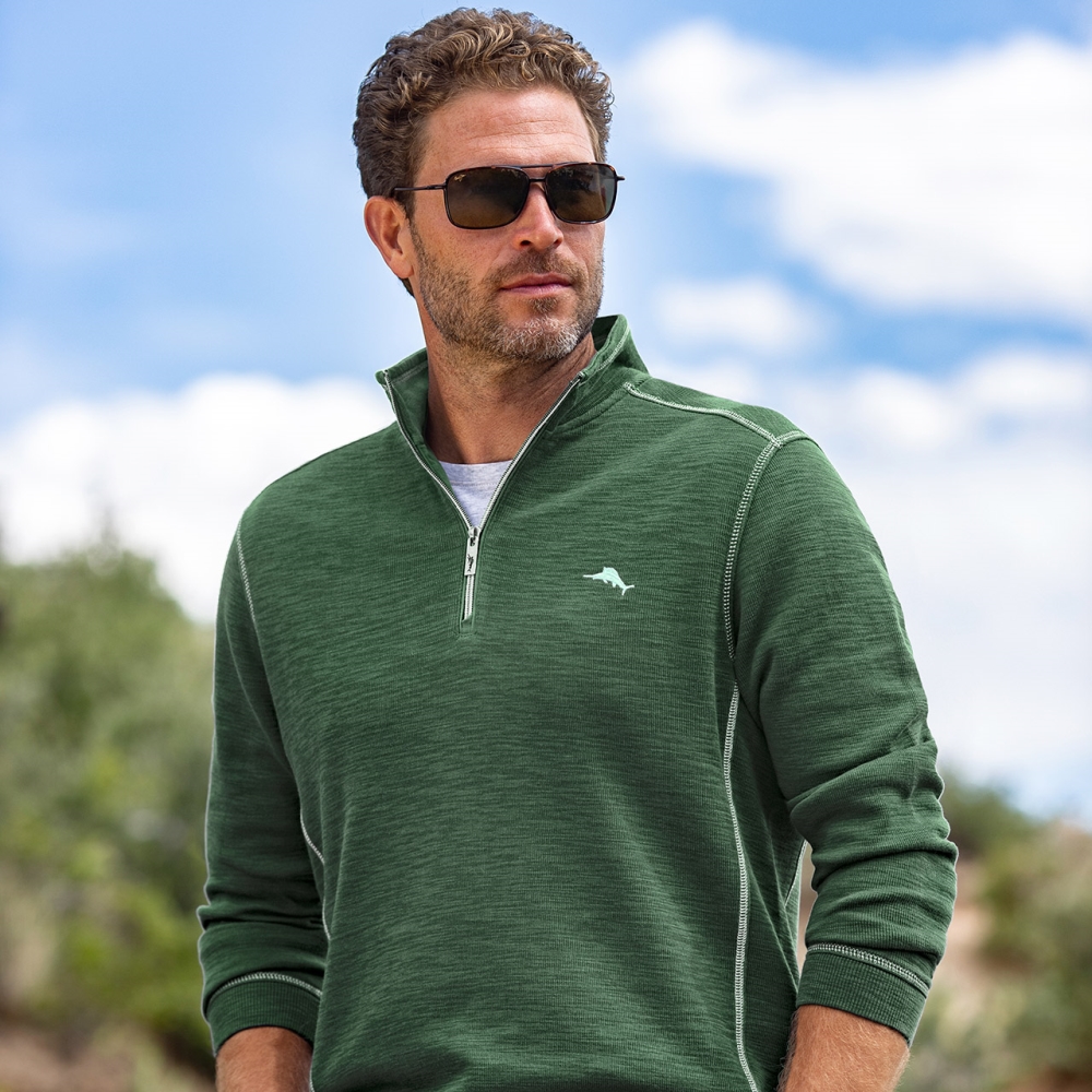 male model wearing tommy bahama green half zipper sweatshirt and sunglasses
