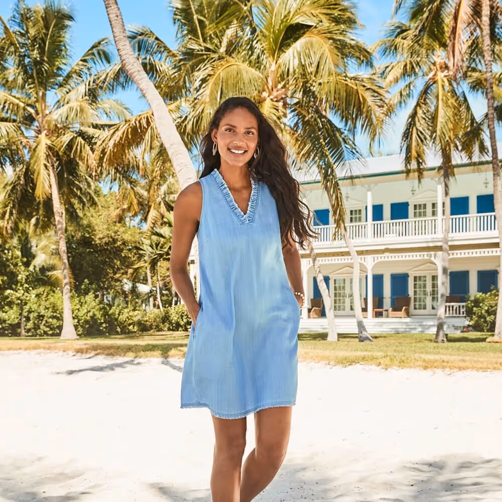 Young woman on a beach in a Tommy Bahama pale denim dress