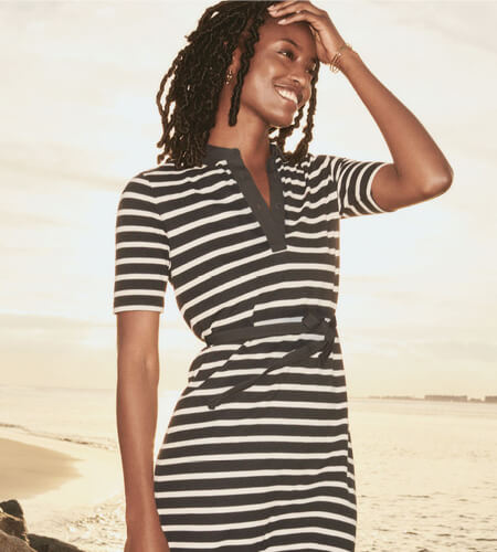 Woman wearing a black and white striped Tommy Hilfiger dress