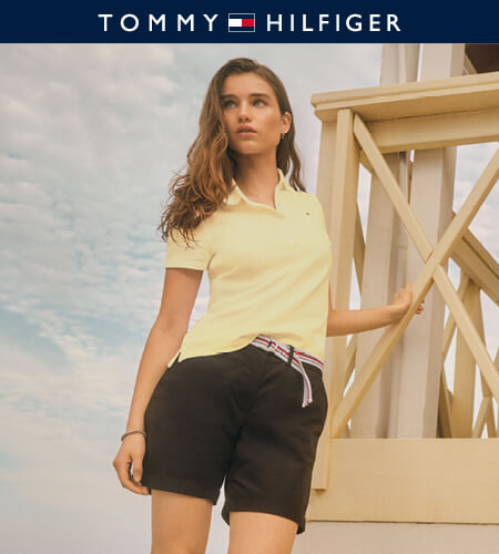Young woman wearing a yellow Tommy Hilfiger polo shirt