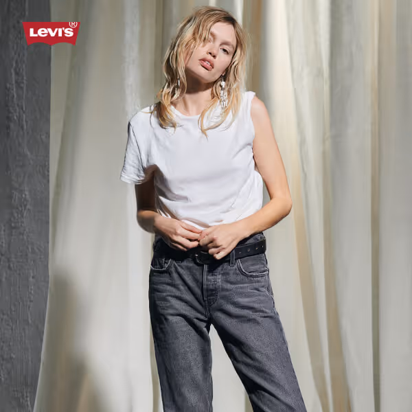 Model wearing Levi's white shirt and gray jeans