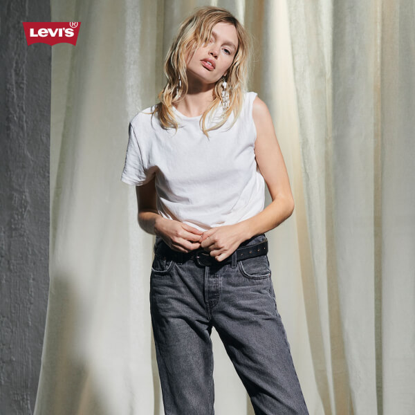Model wearing Levi's white shirt and gray jeans