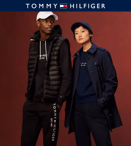 Two models wearing Tommy Hilfiger apparel - one in all black and a white hat, the other in all navy