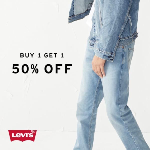 Model wearing Levi's Outlet Store jeans on a white background with black letters saying 'buy 1 get 1 50%off'