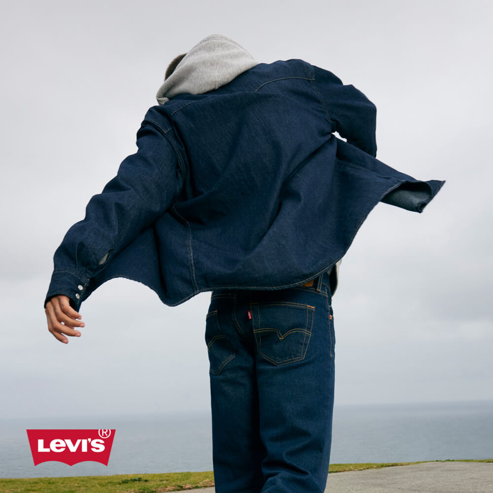Model wearing Levi's denim jacket and jeans