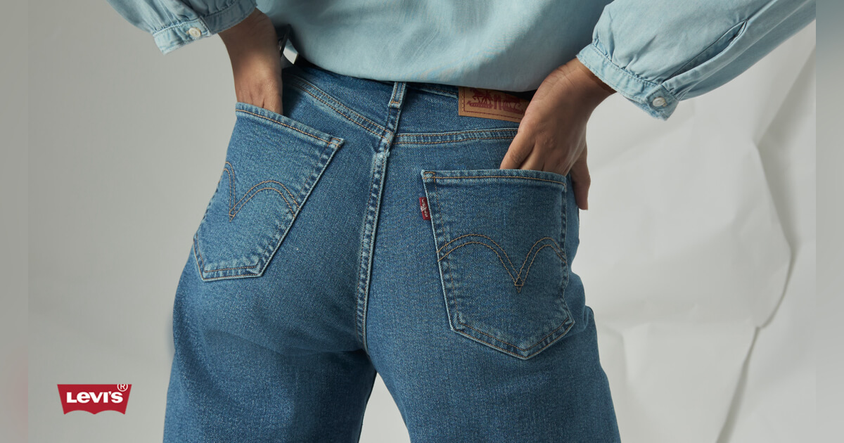 Model wearing Levi's jeans with hands in back pockets