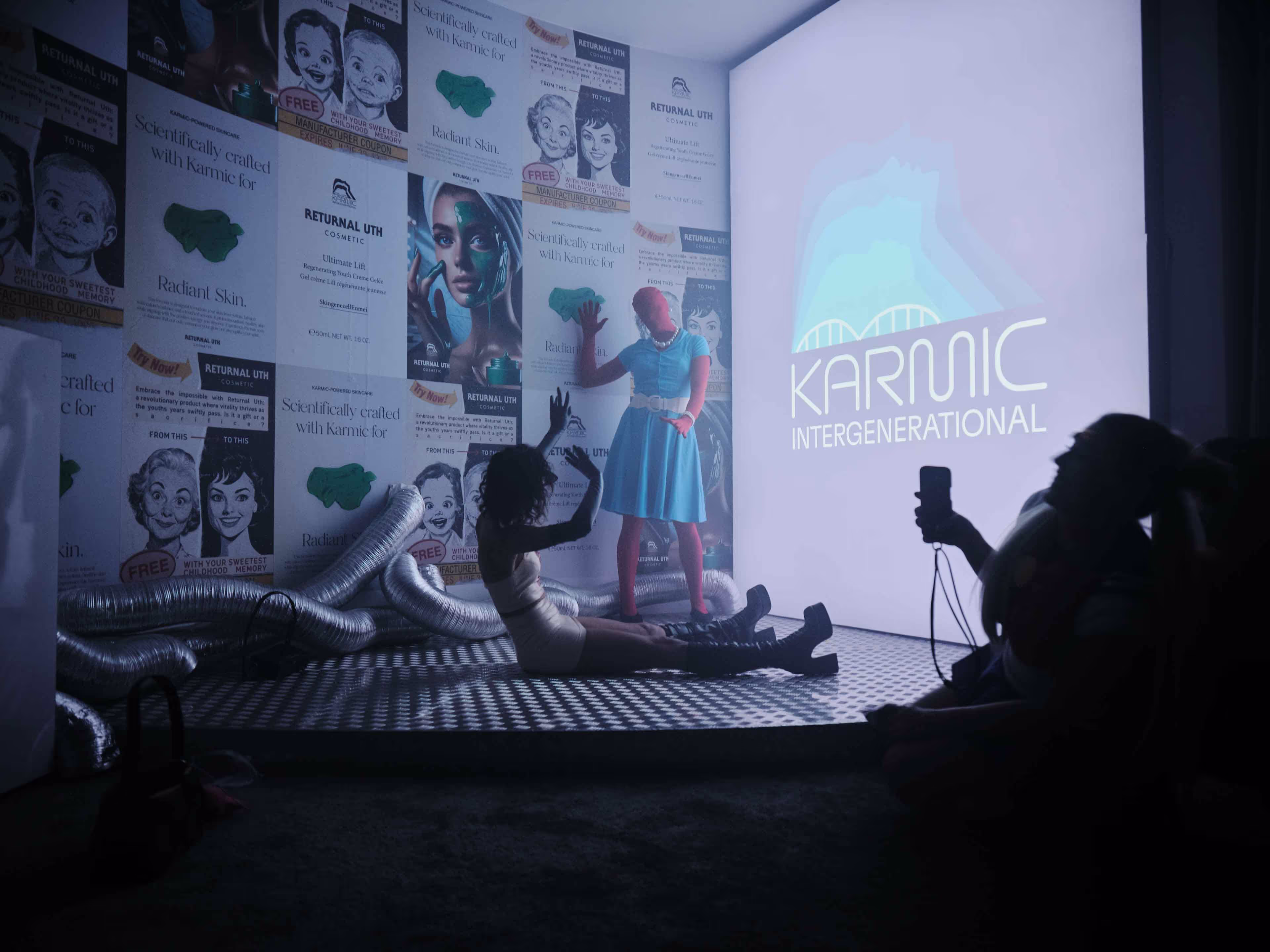 a person in a blue dress standing in a room with a projector