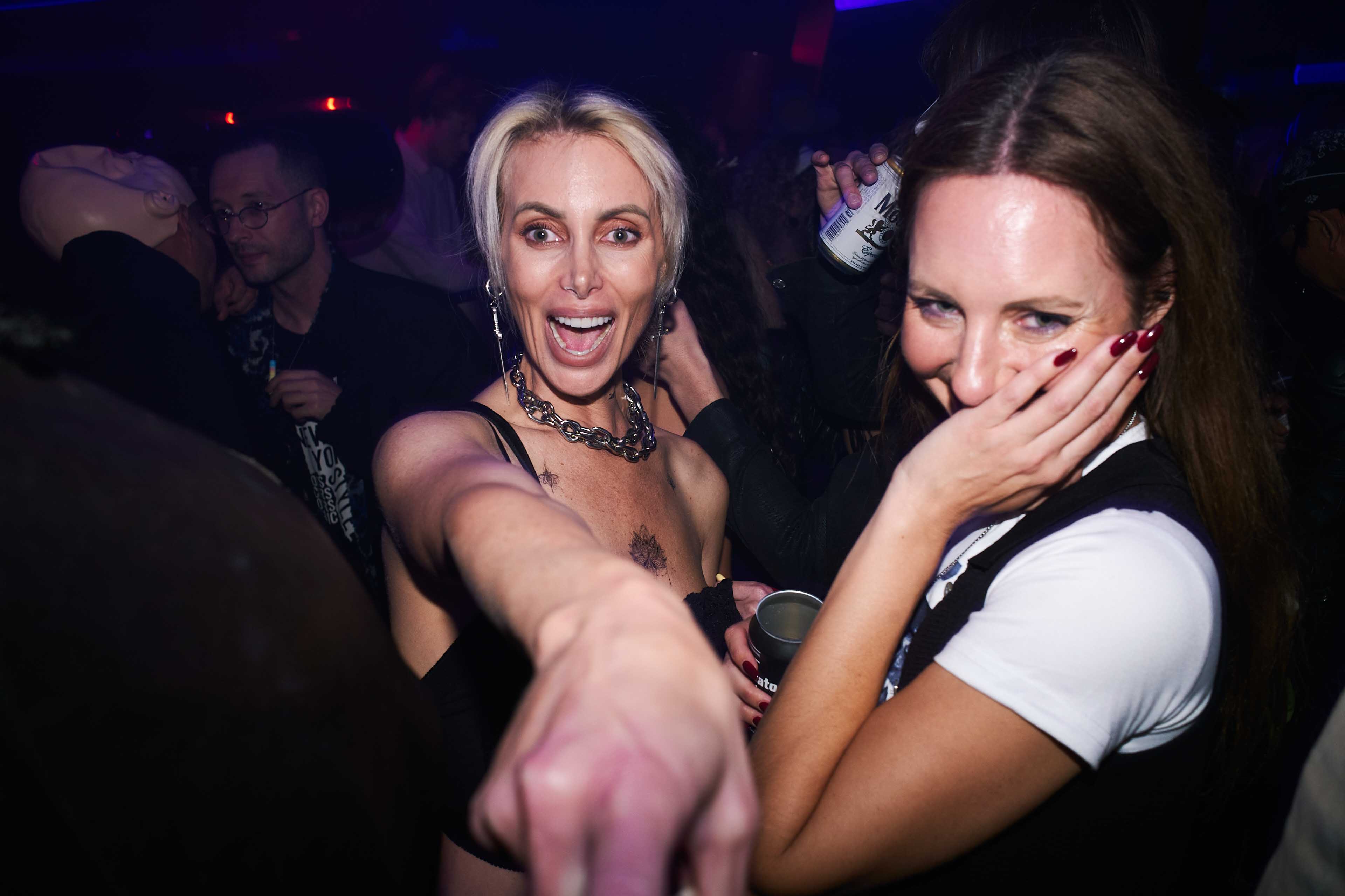 Two women are dancing at a party.